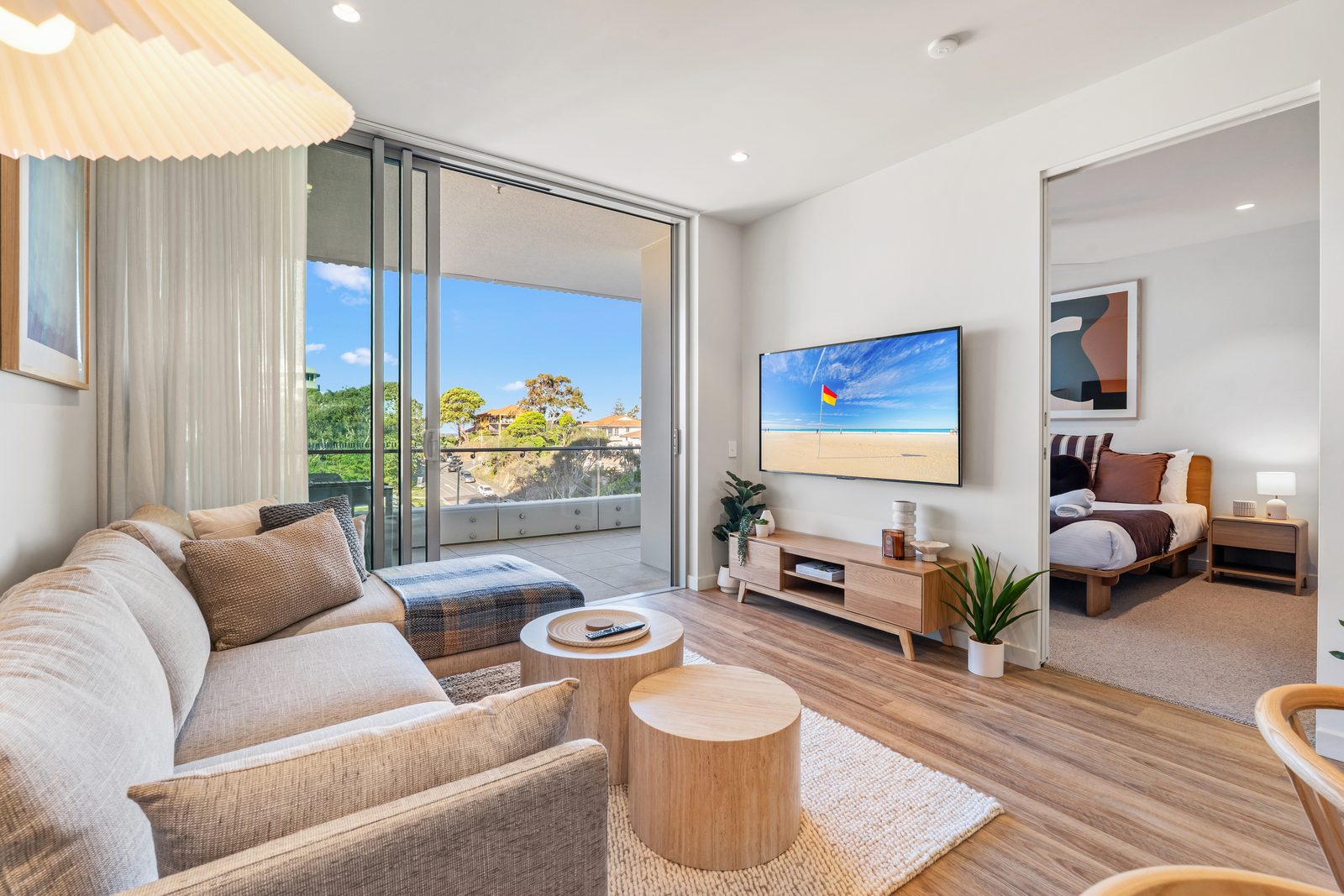 Open-plan living room opening to the private balcony
